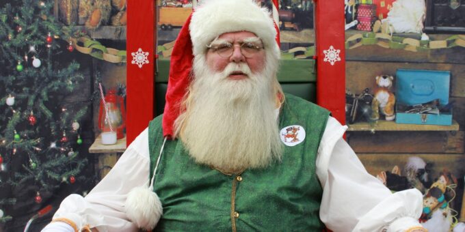 a man dressed as santa claus sitting in a chair