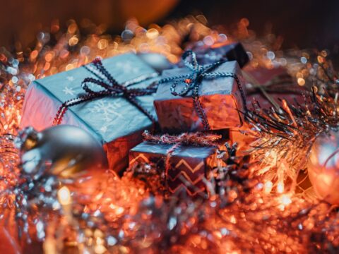 a pile of wrapped presents sitting on top of a table